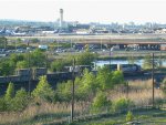 An SD40-2 switches train cars in the shadow of Newark Airport